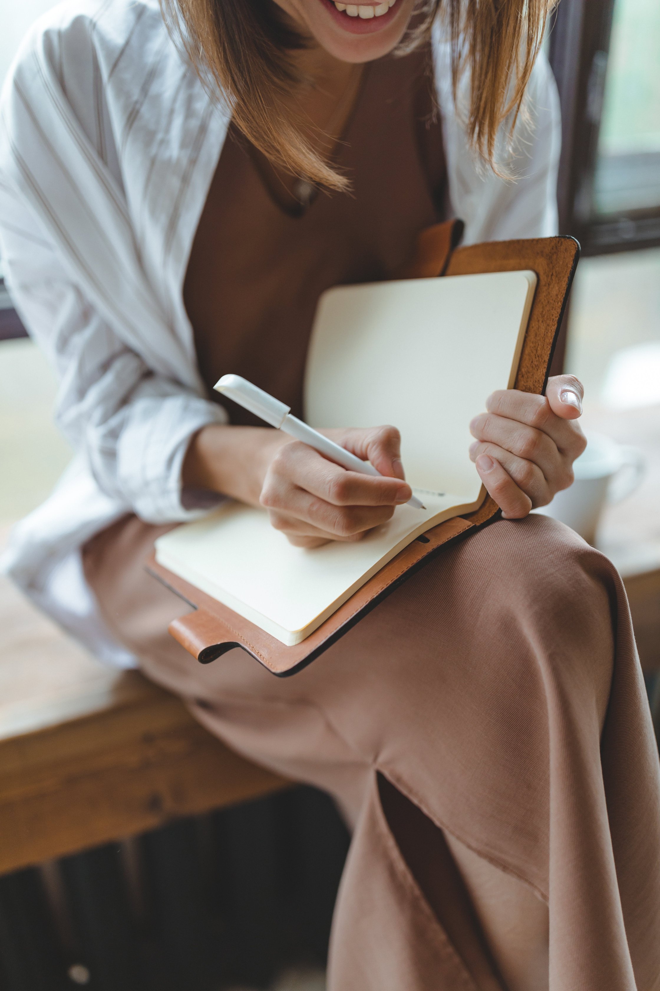 Happy Woman Writing in Journal